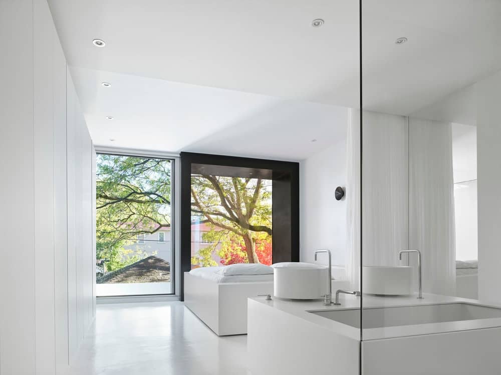 This is a look at the bright modern bedroom and its bathroom just a few steps from the bed.