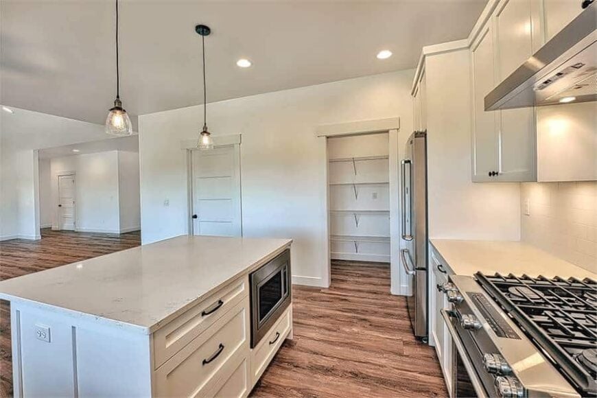 The center island is fitted with white drawers and an oven.