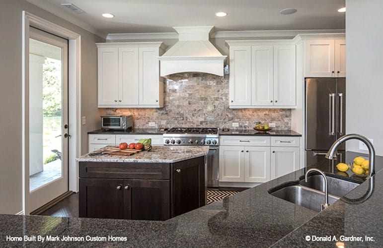 A closer look shows the center island and a glass door that opens to the side porch.