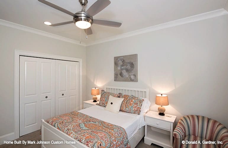 The white double door next to the bed reveals the walk-in closet.