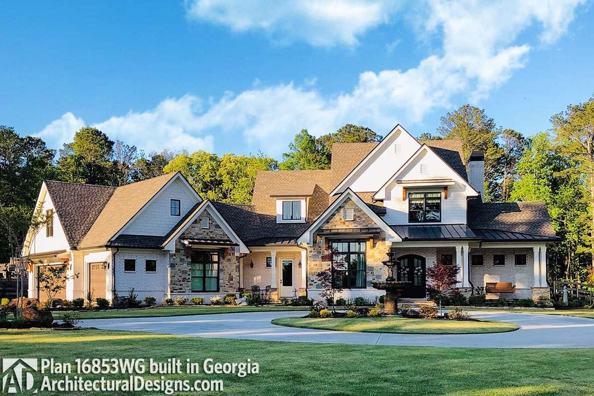 Front exterior view showing the multiple gables, stunning stone accents, and a covered porch.