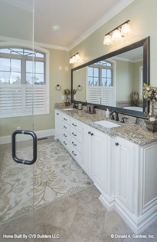 Elegant Bathroom with Expansive Vanity and Granite Countertop