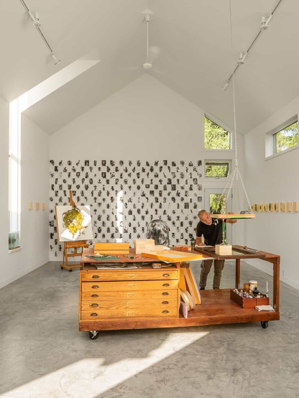 The large area is fitted with a large wooden work desk with wheels and built-in drawers.