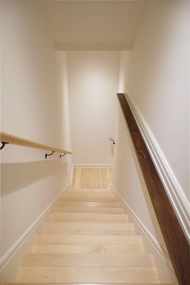 This is a view of the staircase from the vantage of the second floor landing. You can see here that the staircase is enclosed with walls on both sides.