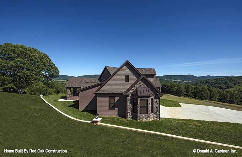Right side view showing the stone and brown siding, along with gable rooflines.