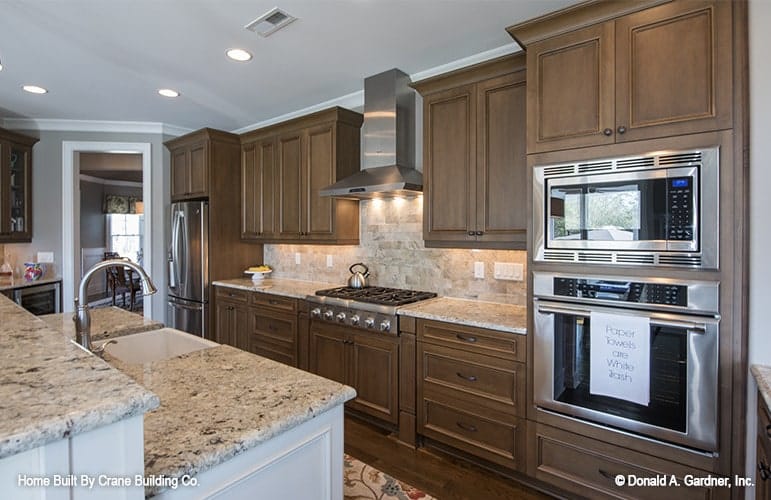 An open doorway beside the fridge leads to the formal dining room.
