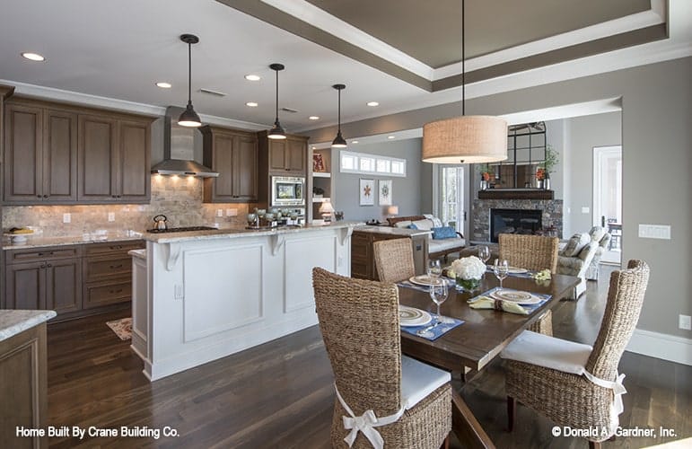 The breakfast book offers cushioned wicker chairs and a wooden dining table well-lit by a drum chandelier.