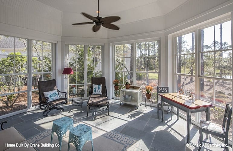 A farther view of the porch showing the massive windows that look out the expansive yard.