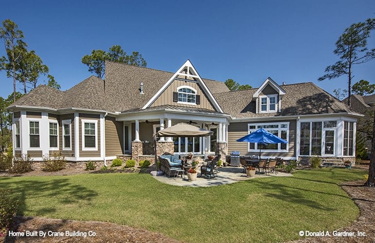 View of the house from the backyard showing the outdoor spaces along with the well-manicured lawn.