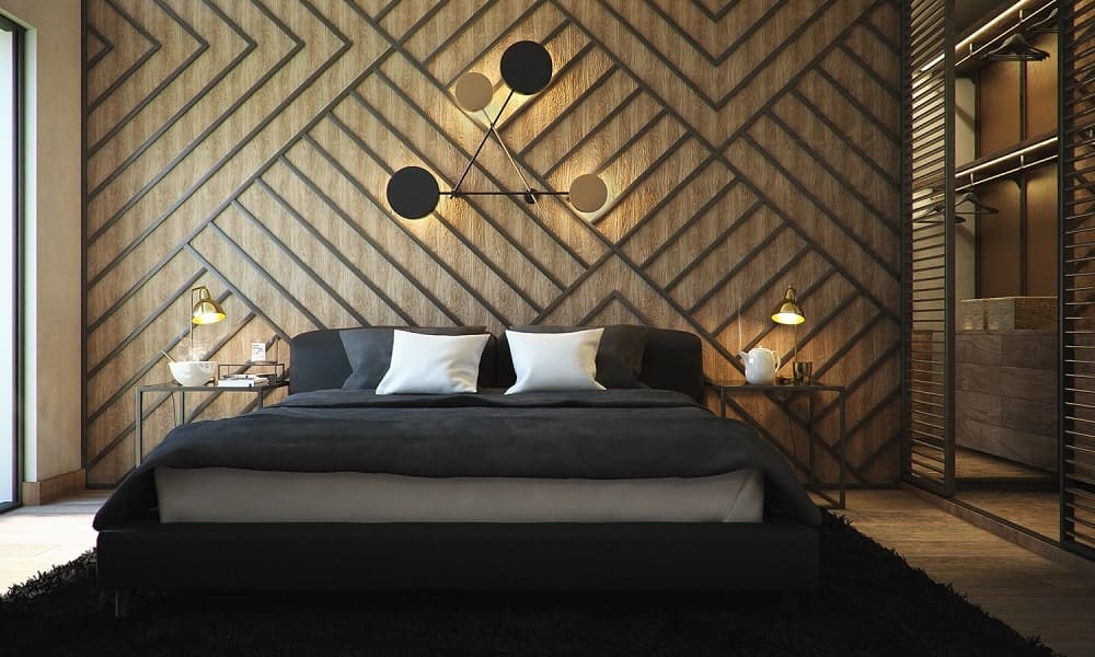 This bedroom has a large patterned wall behind the headboard of the bed adorned with decorative lights and bedside lamps.