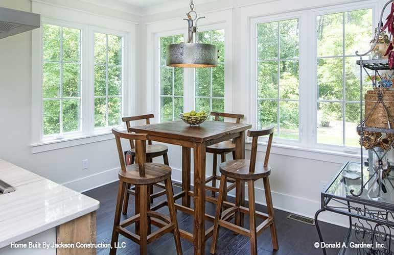 The breakfast nook offers a tall dining table and matching round chairs.