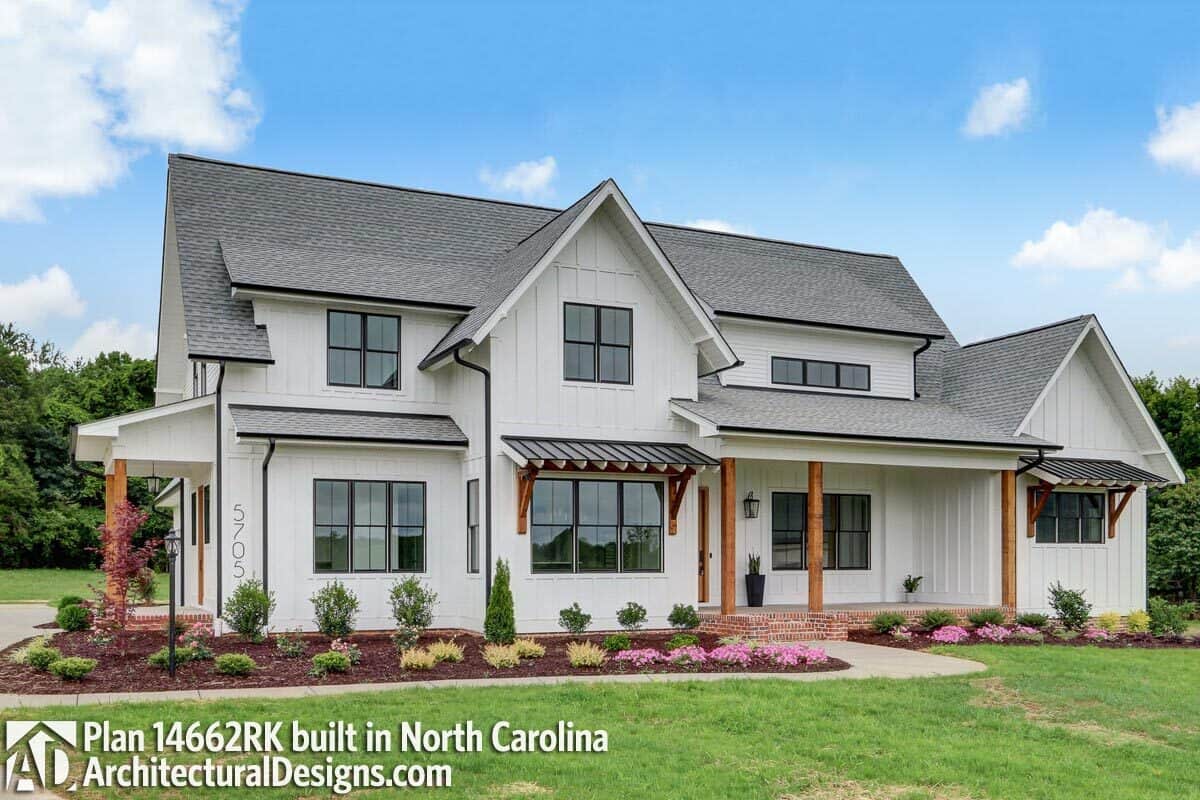 An alternate exterior showcasing a board and batten siding, brick bases, and rustic columns framing the porches.