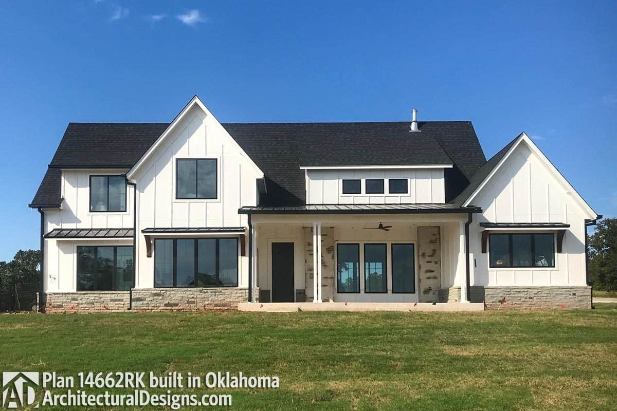 This home features a board and batten siding, stone bases, and a shed dormer that sits on the covered front porch.