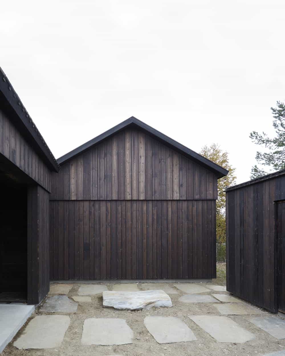 This area of the house outdoor has embedded stone slabs to the ground to serve as walkways between the structures of the house.