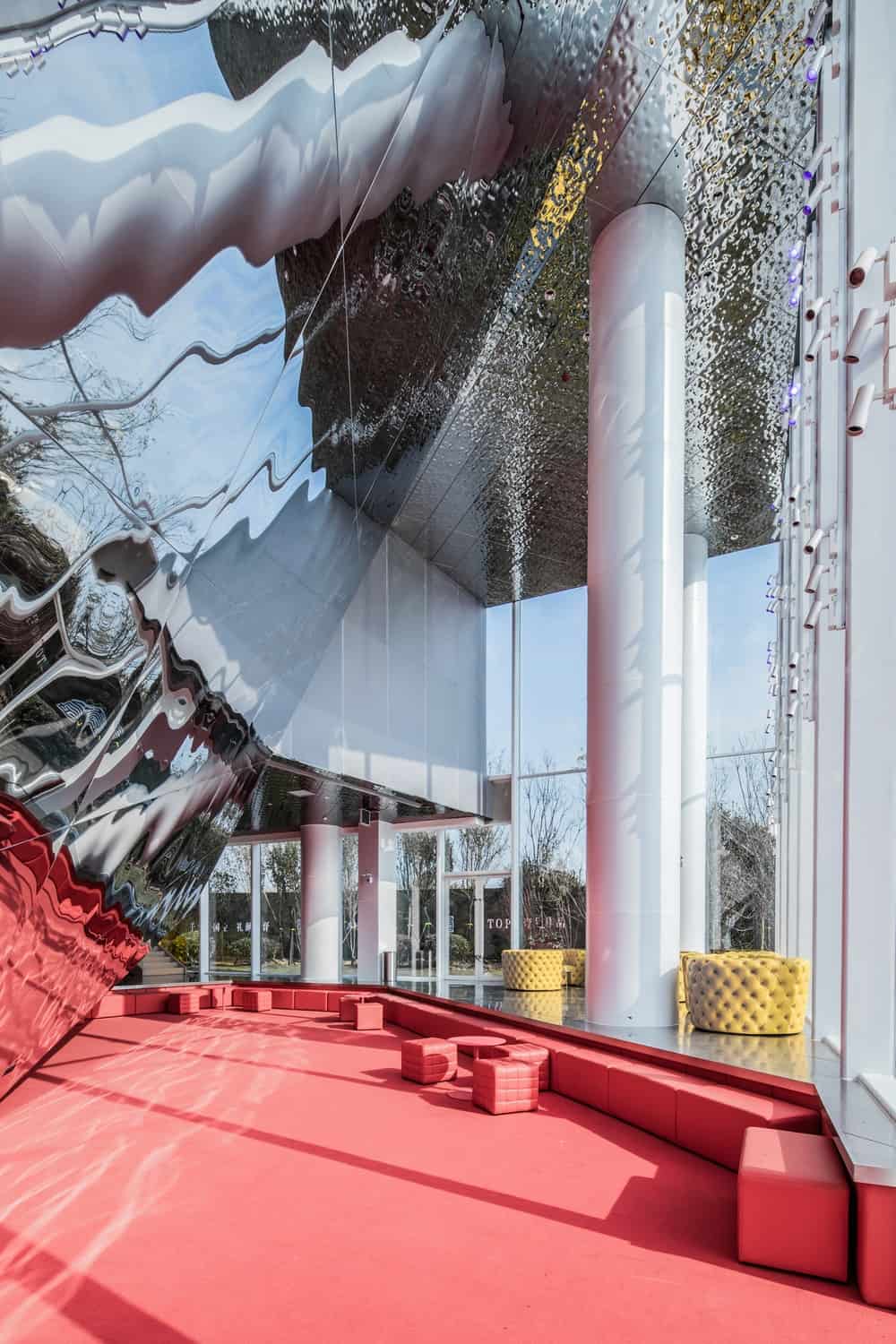 This red area is complemented by the natural lights coming in from the large glass wall the overlooks the water landscape.