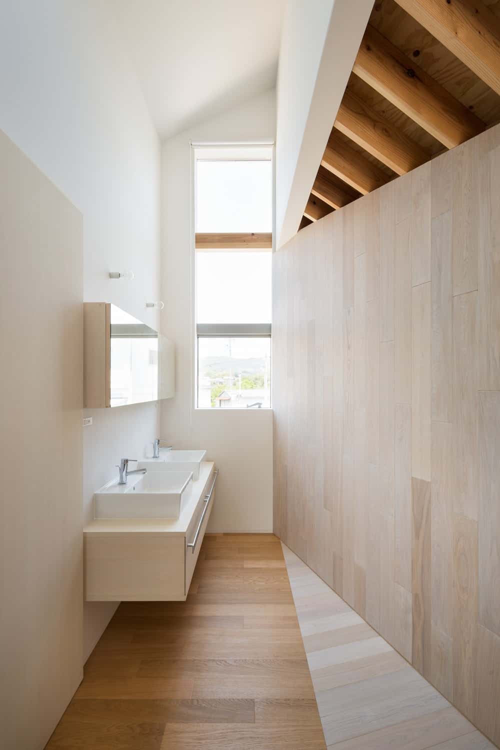 This is the bathroom with a two-sink floating vanity with a beige tone that lets it blend with the wall.