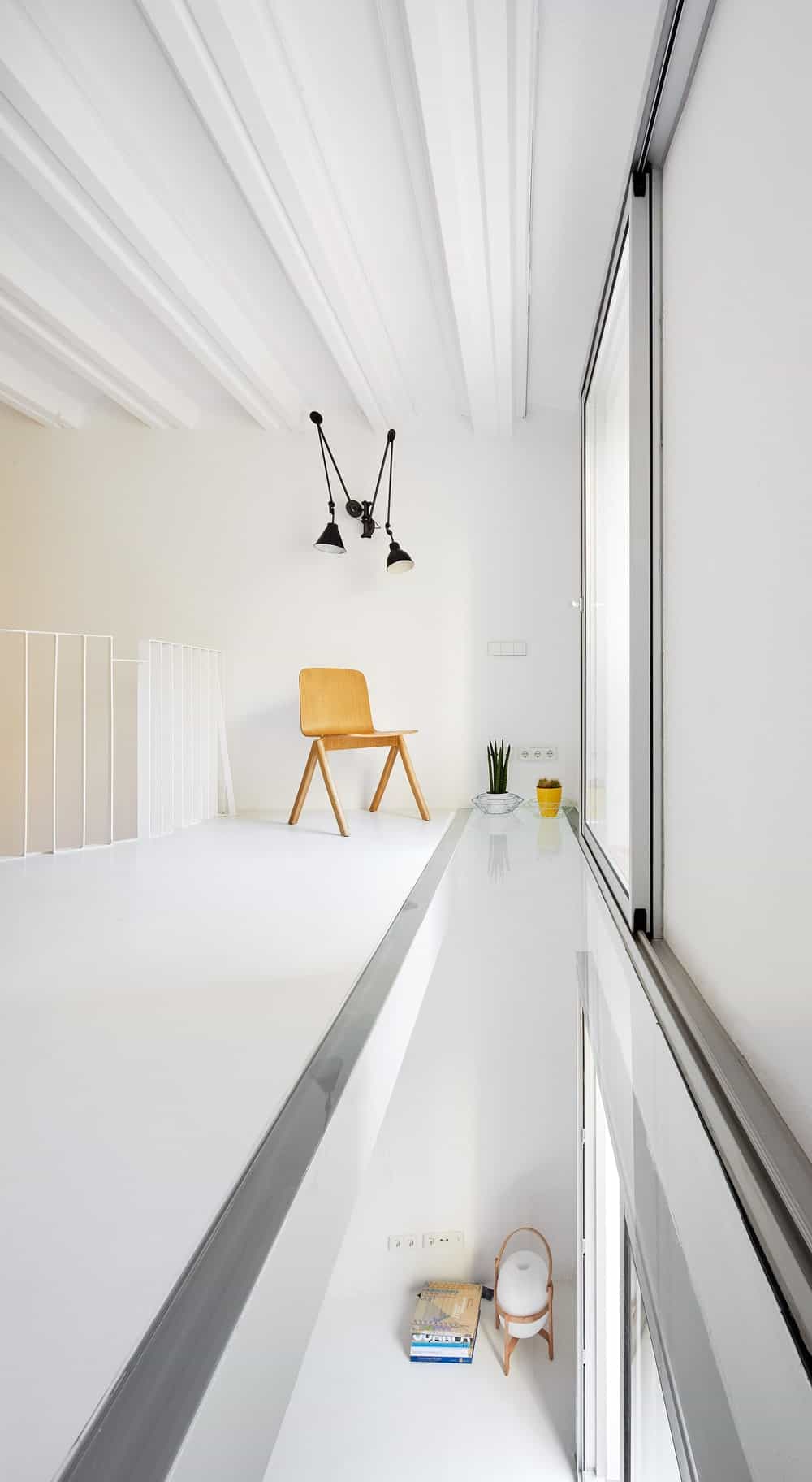 This is the far opposite corner of the kitchen showcasing a glass sliding door and a fiberglass floor panel with a view of the lower floor.