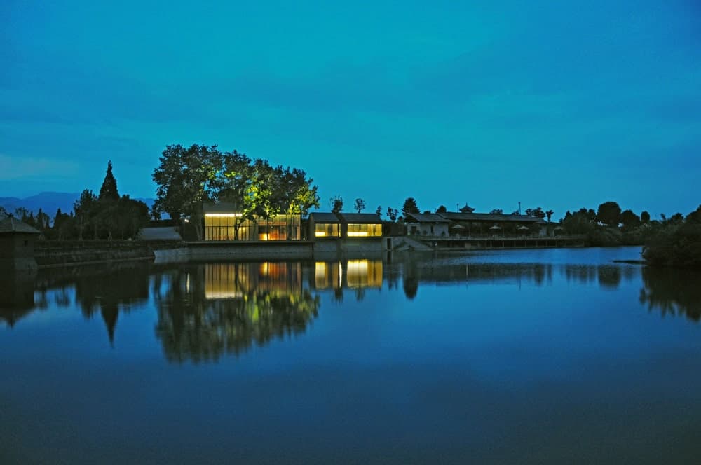 This is a view of the teahouse from the vantage of the water scenery. You can also see here the warm glow of the structures from its glass walls.