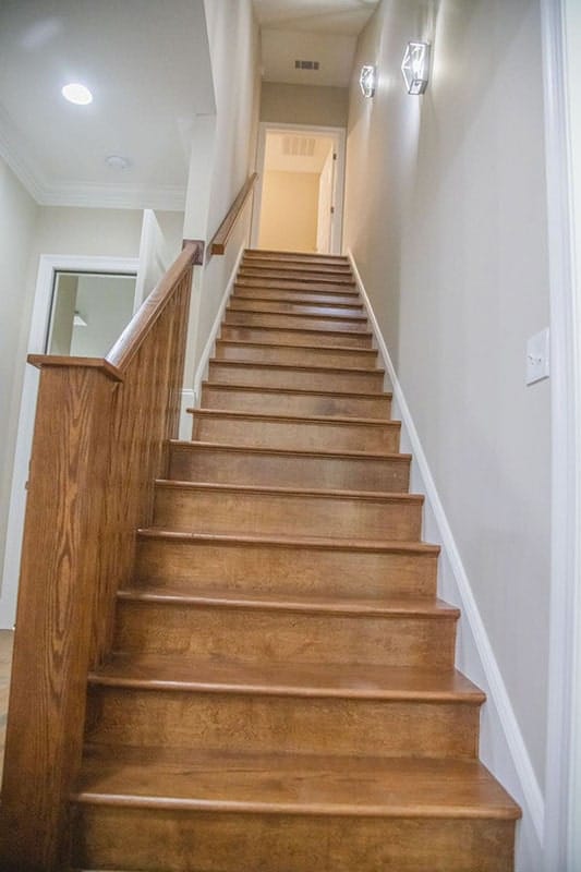 A wooden staircase leading to the bonus room.
