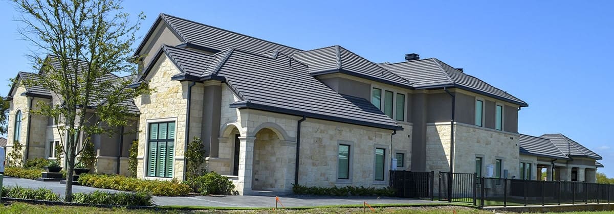 Right exterior view with hipped rooflines and plenty of glass windows.