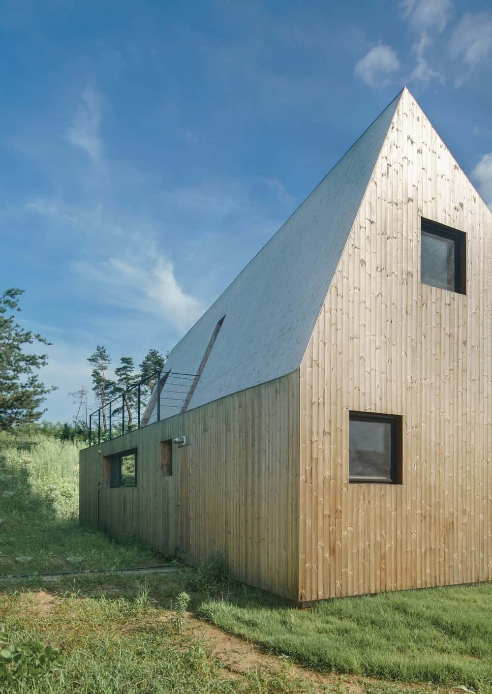 This is a close look at the simple and small windows of the house with wooden exterior walls.