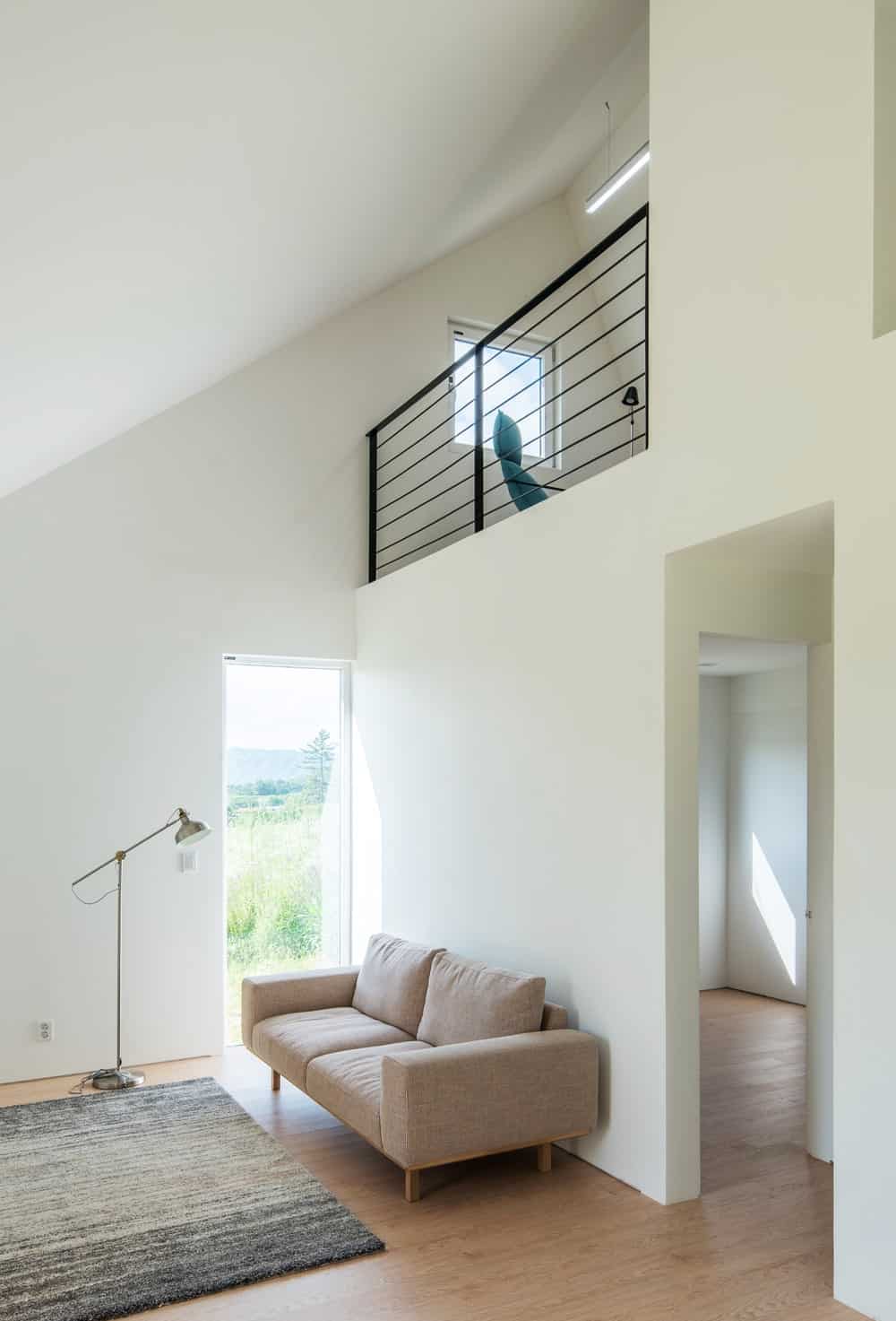 This look at the living room showcases the wrought iron railings that stand out against the bright walls.