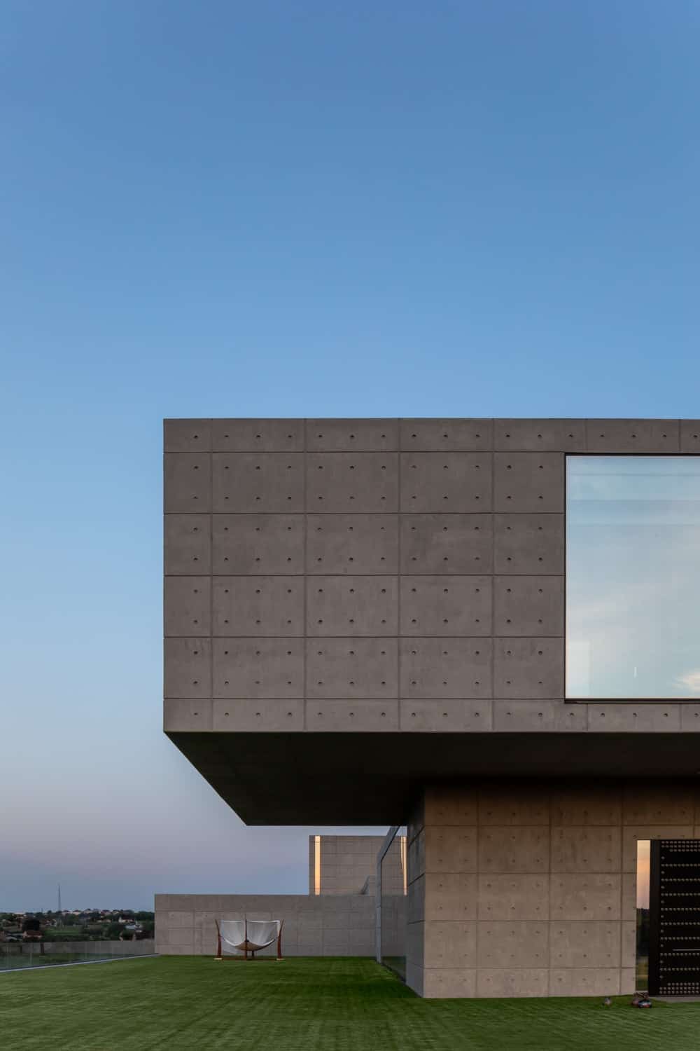 This is a look at the concrete exterior walls of the house that contrasts the glass wall of the second level.