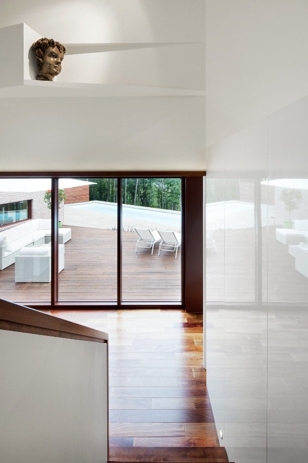 This is a look at the interior of the house from the vantage of the landing looking down at the hardwood flooring.