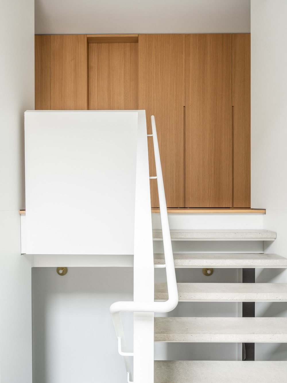 The steps of the stairs are supported by the banisters and walls on its sides.