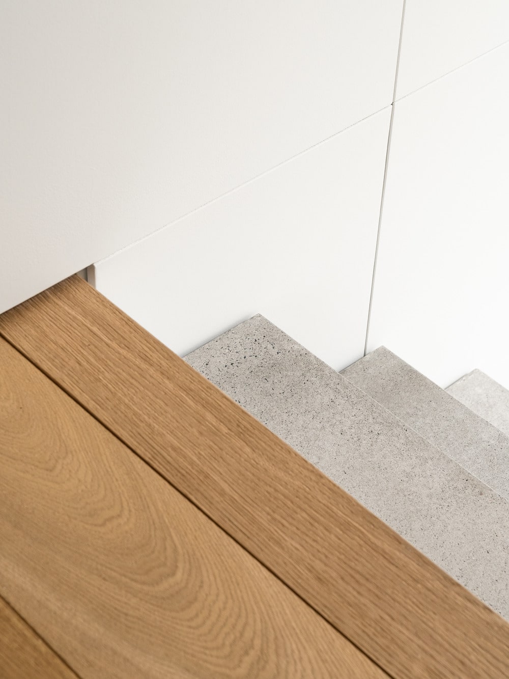 This is a look down the stairs from the vantage of the landing that has a hardwood flooring.