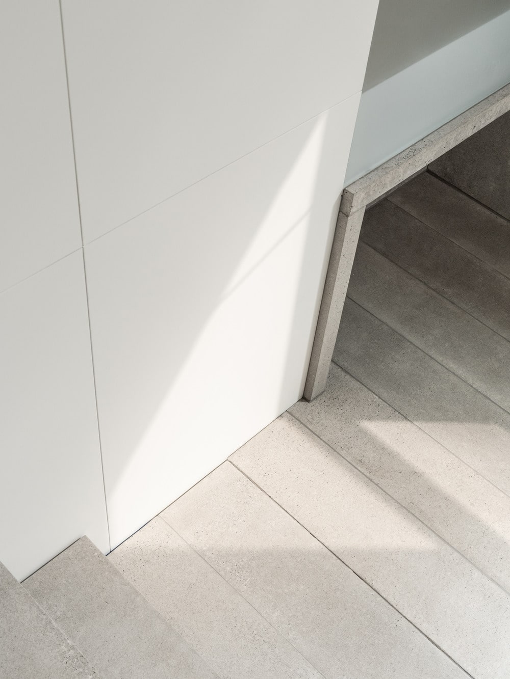 This provides a small alcove at the foot of the stairs that provide an area for shoe storage.