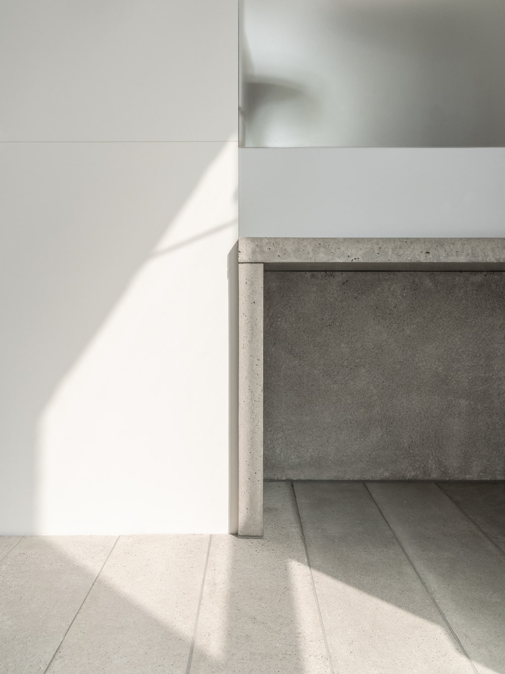 On the side of the foyer is the built-in concrete console table topped with a mirror.