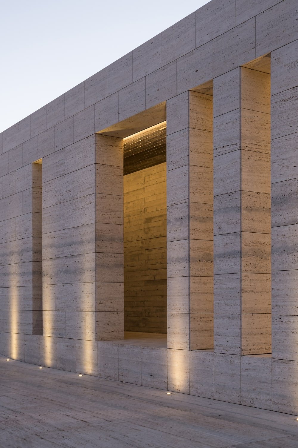 This is a close look at the pillars and walls complemented by the warm yellow light of the outdoor lights.