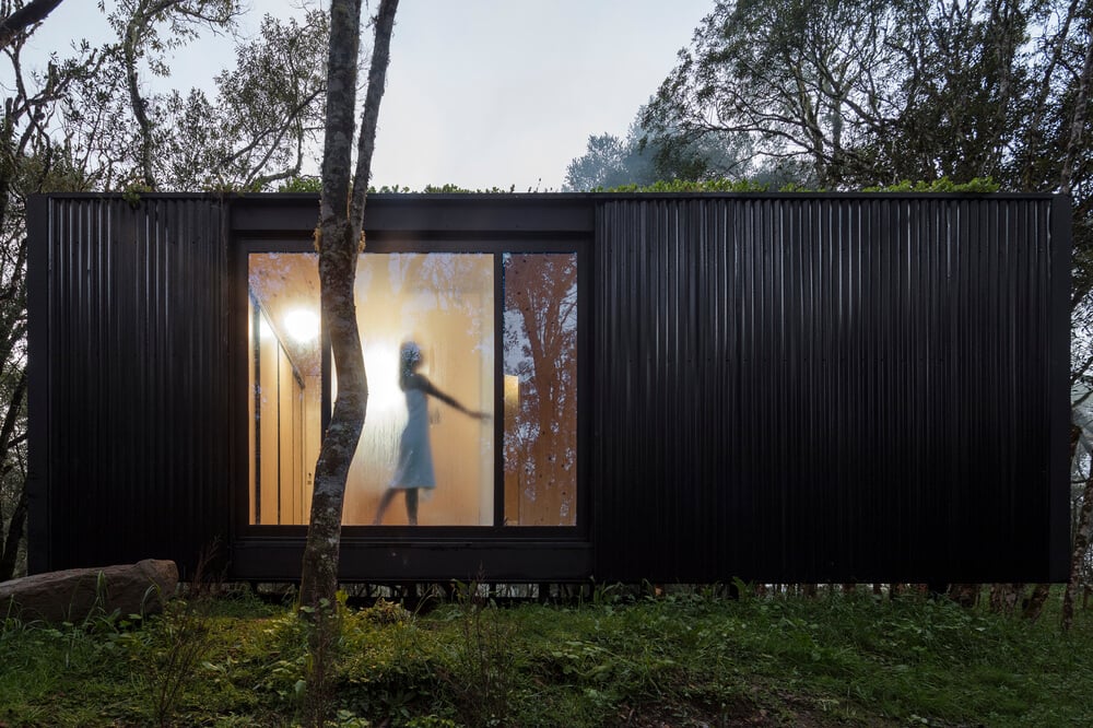 This side of house has dark textured exterior walls that make the window stand out.