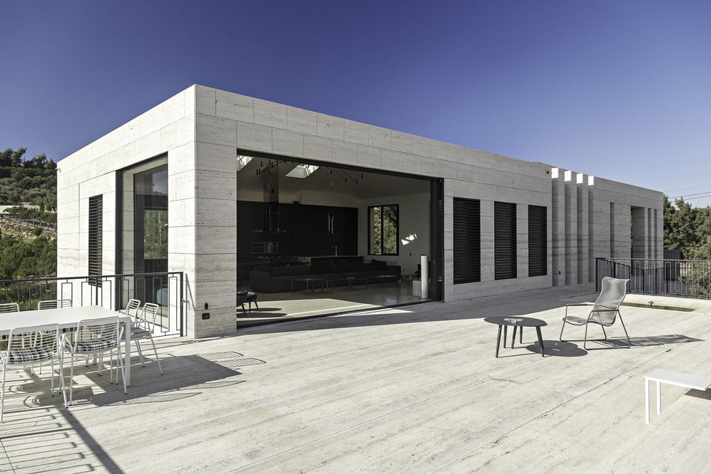 This is a close look at the upper floor of the house that has a large opening to assimilate the indoor and outdoor areas.