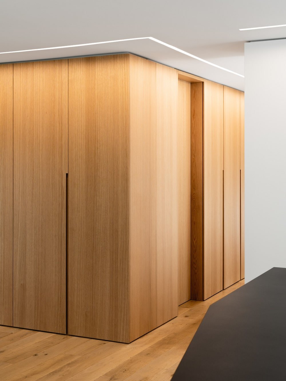 The top of the wooden structure has a modern lighting.