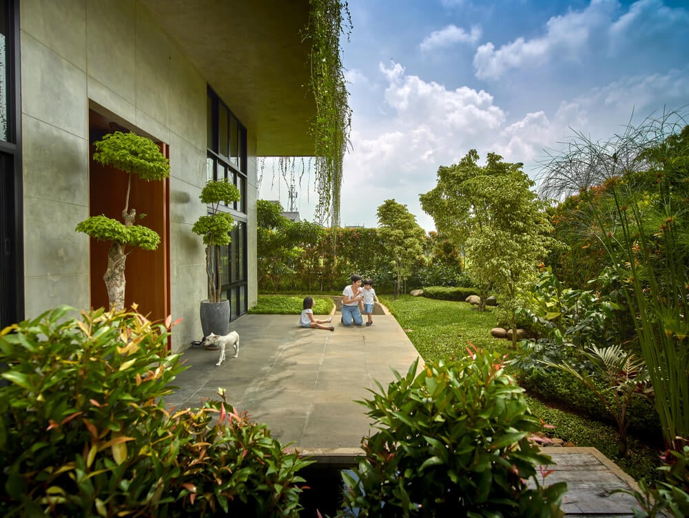 This is the outdoor play area with a concrete floor before transitioning to the garden area of the landscape.