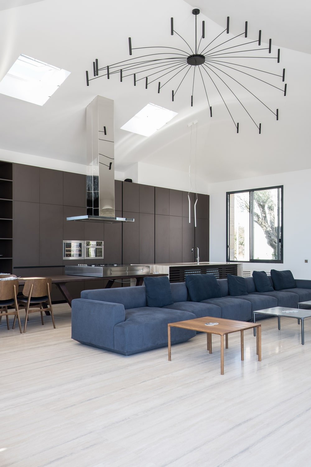 This is a view of the living room and the large modern cabinetry of the kitchen in the background.