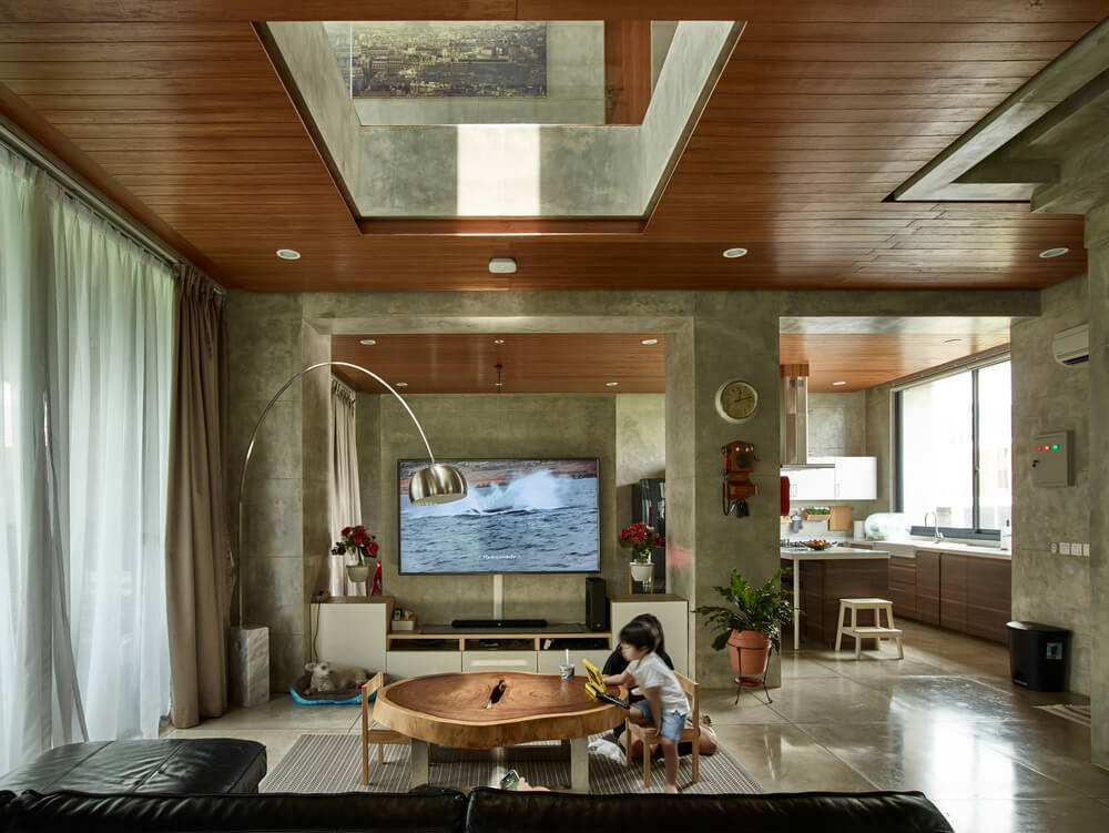 The L-shaped sofa is paired with a large wooden coffee table topped with an indoor balcony.