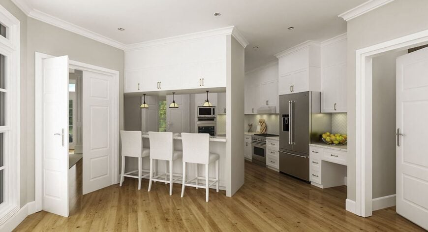 Kitchen with white cabinetry, stainless steel appliances, and an angled peninsula.