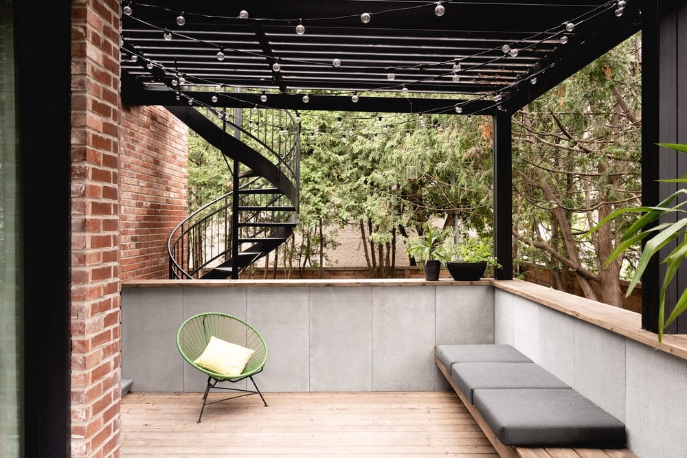 The house also has a balcony terrace topped with a set of trellises.