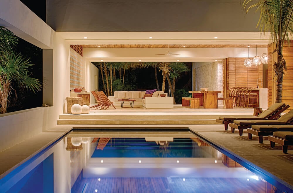 A few steps from the living room is the poolside area that has lounge chairs facing the pool.