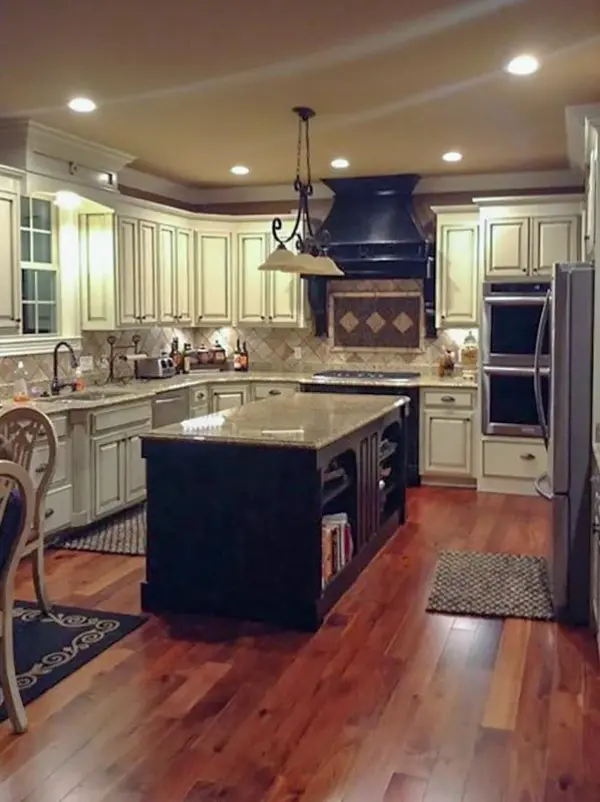 There's also a large island paired with a wrought iron pendant light.