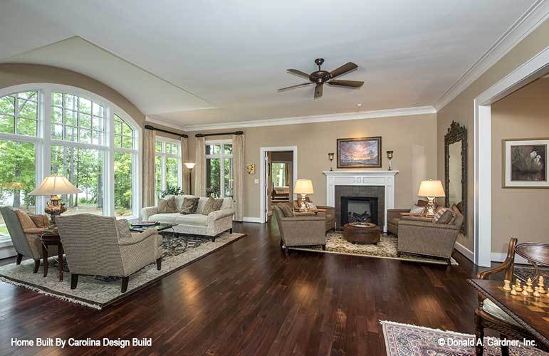 The living room includes a fireplace adorned with a wooden framed painting.