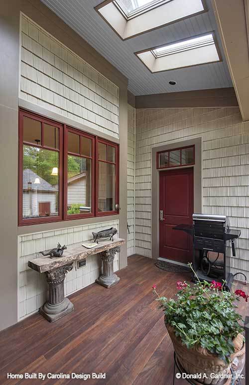 Covered porch with hardwood flooring and skylights.