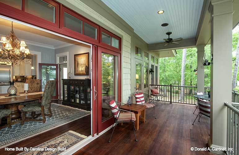 The rear porch includes sliding glass doors that open to the dining room.