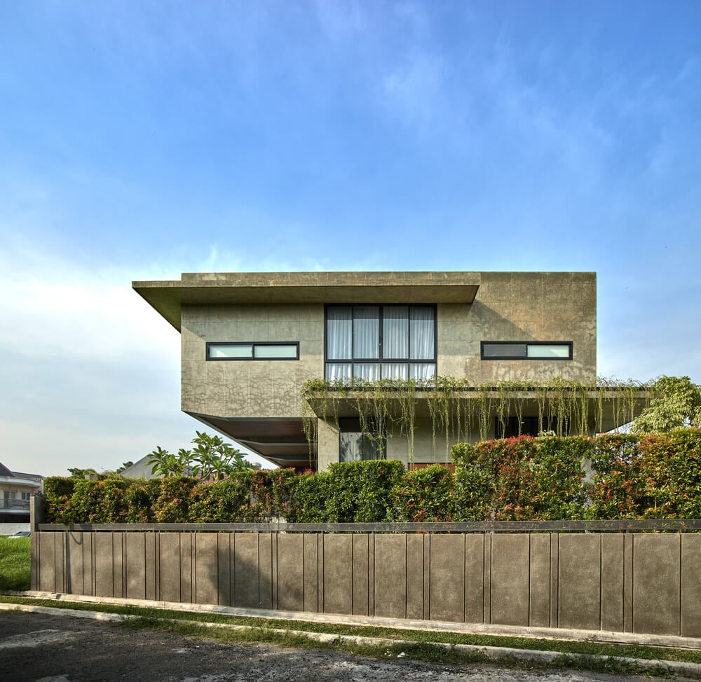 This is an exterior view of the house elevation showcasing the large glass wall on the upper level.