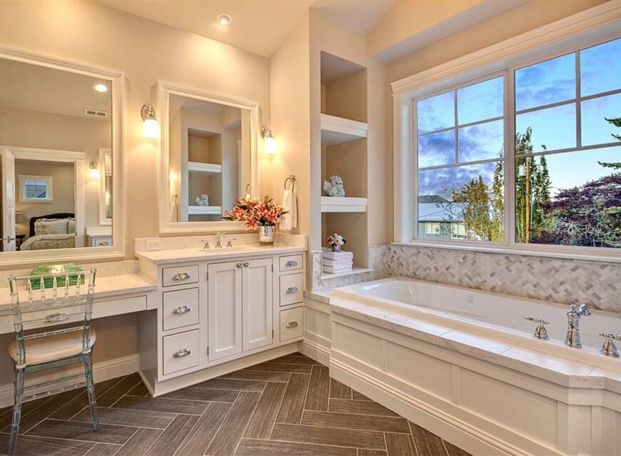 An elegant glass chair complements the bathroom vanity.
