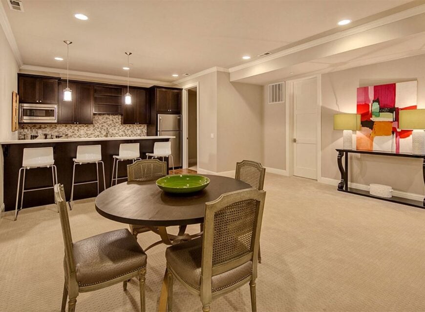 A round dining set and a wet bar complete the recreation room.