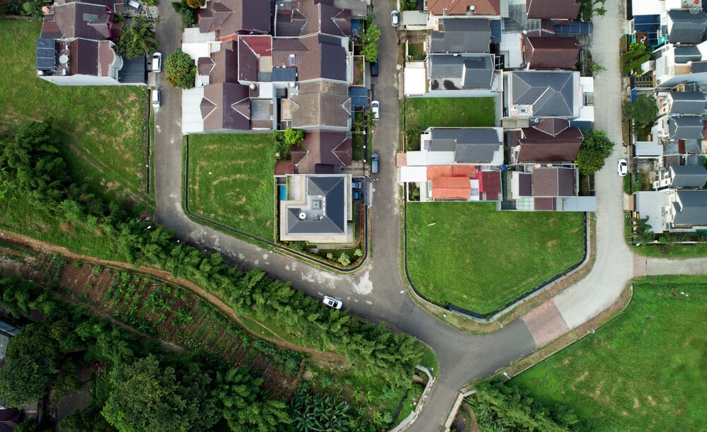 This is an aerial view of the house showcasing the neighborhood surrounding the house.